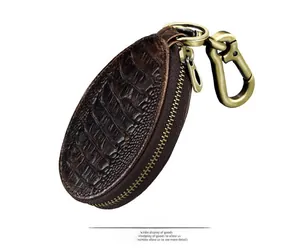 Detailed side view of dark brown crocodile texture leather car key case with brass clip