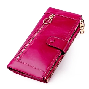 Detailed macro view of retro oil wax leather texture and gold hardware on long wallet