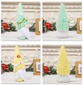 Detailed close-up of knitted Christmas gnomes with faux pearls and plush white beards