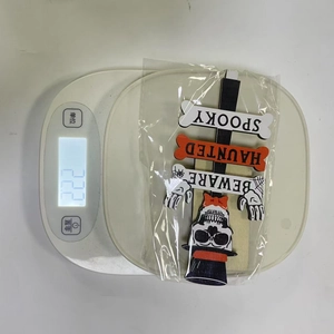 Detailed view showing a lightweight Halloween wooden Spooky sign weighing 22.2g on a scale