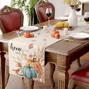 Close-up of linen table runner with fall pumpkin patterns and Home Sweet Home text