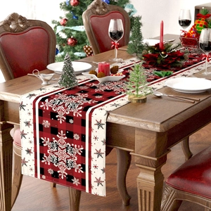 Close-up of red and black buffalo check Christmas table runner with snowflake patterns