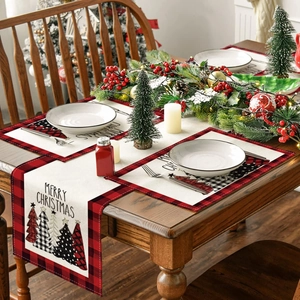 Close-up of Merry Christmas linen table runner and placemats with plaid borders and trees