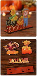 Macro view of DIY Thanksgiving wooden desktop set with Scarecrow and Pumpkin ornaments