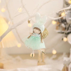 Green tulle dress bunny angel ornament hanging on branches with warm bokeh lights