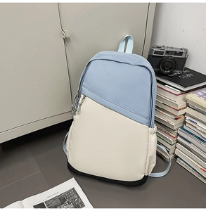 Detail of multi-color business backpack with beige body and blue top on a modern background