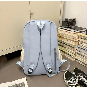 Detail view of the ergonomic padded straps on a water-resistant blue nylon backpack