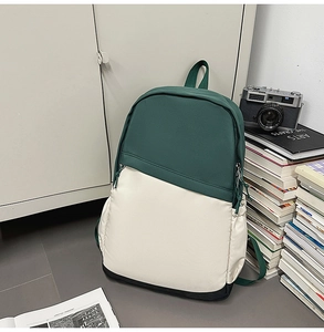 Three-color nylon business backpack with side pocket shown in a minimalist study setting
