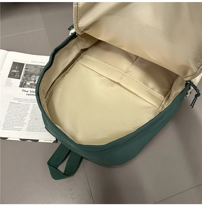 Interior view of a dark green business backpack featuring a spacious main compartment