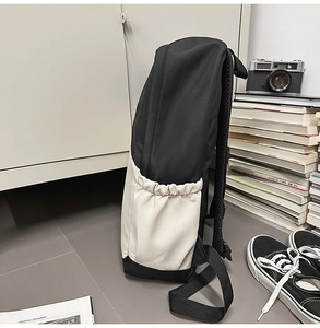 Detail view of the nylon business backpack showing the side elastic pocket and canvas texture