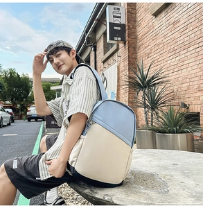 Outdoor backpack with blue and beige patchwork design shown in a scenic urban setting
