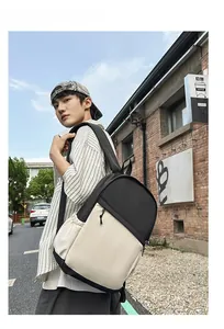 Casual nylon business backpack with side pocket shown on model against a brick wall