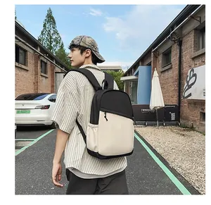 Outdoor shot of a man wearing a waterproof nylon commuter backpack in black and white