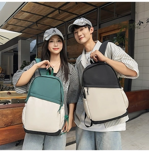 Detail of color-block nylon waterproof business backpacks on male and female models