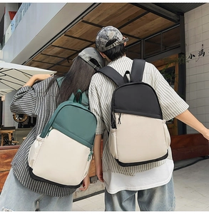 Rear view of duo-tone nylon backpacks in green and black for urban commuting