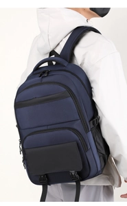 Side view of deep blue business backpack featuring durable fabric and multi-pocket design