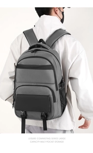Detailed back view of a grey waterproof nylon business backpack with multiple compartments