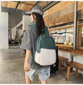 Detailed side view of water-resistant nylon backpack in olive green and beige colors