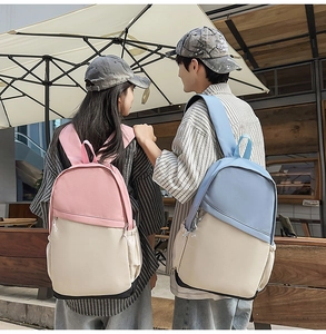Outdoor view of pink and blue nylon backpacks with side pockets for daily commuting