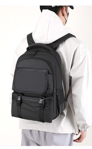 Detailed back view of a black multi-pocket laptop backpack featuring secure buckle straps