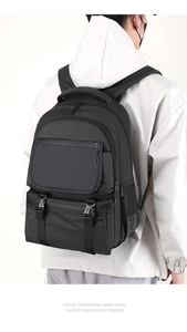 Detail of ergonomic padded straps and side pockets on a durable black nylon laptop backpack