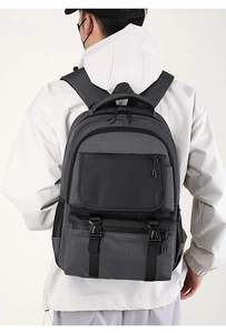 Detailed back view of a minimalist grey commuter backpack with reinforced buckles