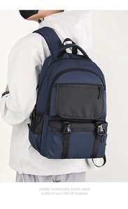 Side view of a navy blue commuter backpack with buckles and mesh pockets on a male model