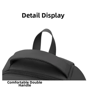 Close-up of the reinforced comfortable padded handle on a dark grey waterproof laptop backpack
