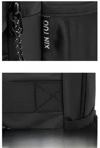 Detail of reinforced luggage strap and brand logo label on black business backpack