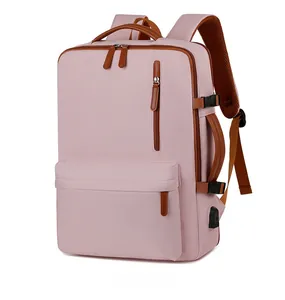 Pink Oxford fabric laptop backpack detail featuring USB port and brown leather accents