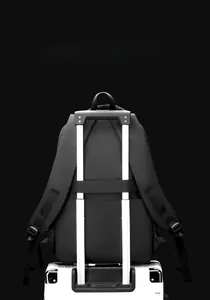 Detail of the luggage strap on a black business backpack attached to a suitcase handle