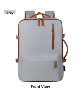 Front view of grey oxford backpack with USB charging port and brown leather accents