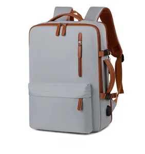 Detailed view of gray Oxford fabric backpack with brown leather trim and USB port