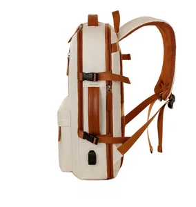 Side view of white water-resistant laptop backpack with USB port and brown leather handle