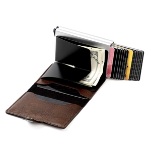 Detail view of brown leather RFID blocking wallet showing the pop-up card mechanism and money clip