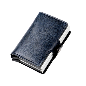Detail view of navy blue lychee grain leather wallet with secure metal snap closure