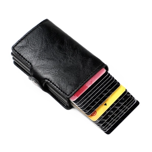 Detail of black leather RFID card holder showing the automatic pop-up aluminum mechanism