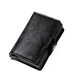 Detail of black pebbled leather RFID blocking pop-up wallet with metal side button