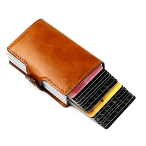 Detail of brown leather RFID card holder with aluminum pop-up slot and snap fastener