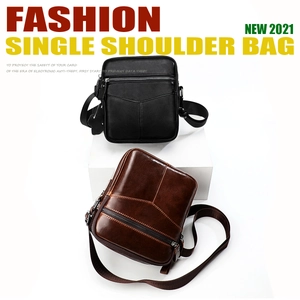 Detail view of leather men's chest bags with V-shaped stitching and metallic zippers