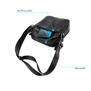 Detail view of the black crossbody bag featuring a zip phone pocket and main storage