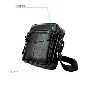 Detail view of the main pocket and hidden zip pocket on a black leather chest bag