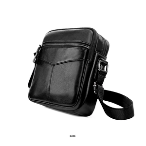 Side view of black faux leather chest bag showing texture and silver zippers