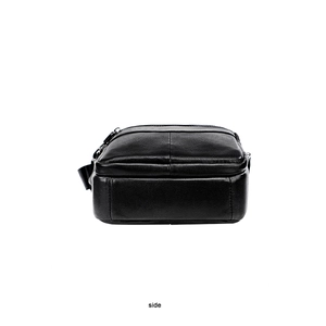 Side view of black lychee grain leather sling bag with gunmetal grey hardware details