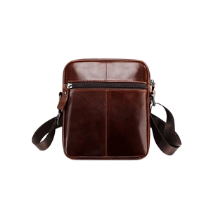 Detail of vintage brown leather chest bag showing premium texture and zipper compartment
