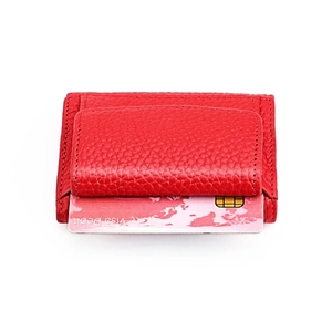 Close-up of red pebble leather wallet with card slot and flap for compact storage