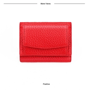 Detailed view of red pebble grain leather wallet with precision stitching and flap closure