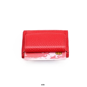 Detail of red pebble leather wallet showing compact card slot and secure stitching