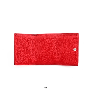 Detail view of red lychee grain leather wallet showing fine stitching and metal clasp