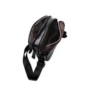 Men's black leather crossbody chest bag with double zipper compartments and nylon strap